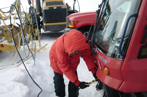 Back after three and a half hours.  Me plugging in the snowmobile&#39;s engine block heater.