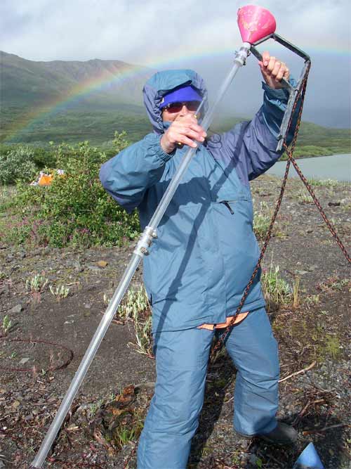 Barney holds an extra long sediment trap designed for 3 years of collecting.