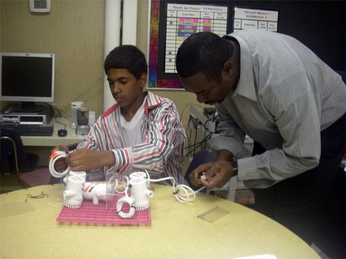 Dajon and Mr. Wagner attach the  thrusters.