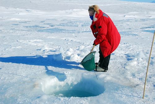 I am scooping ice out of the dive hole.