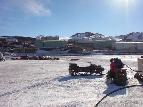 DJ puts gas in the snowmobile.