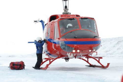 A helo tech unloads the vehicle.