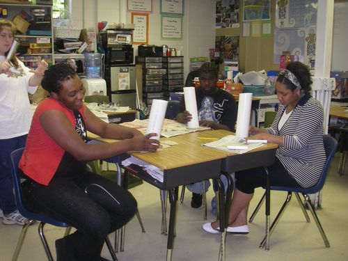 Antonio, Vernon, and Jasmine are sanding the ends of the three inch PVC pipe pieces.