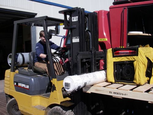 Kim drives the forklift.