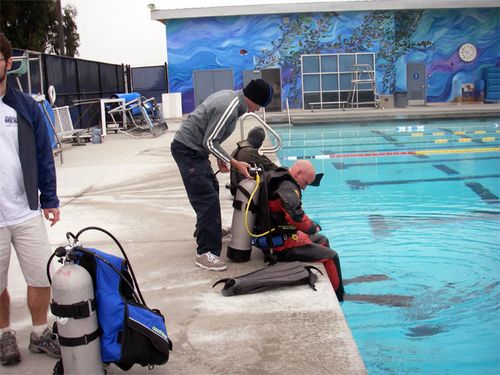 A diver will use a tank of compressed  air to breathe underwater.