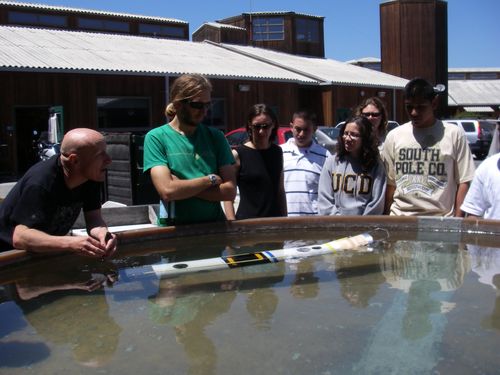 A group of young visitors listen to  Bob explain SCINI.