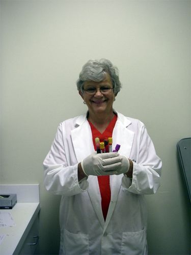 The lab technician, Grace, holding all  the viles of my bood that will be  tested.