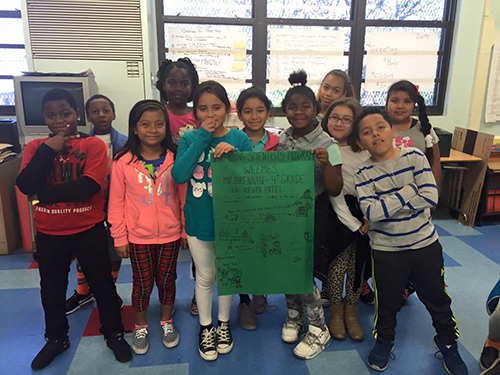 Fourth grade students at Weemes with banner