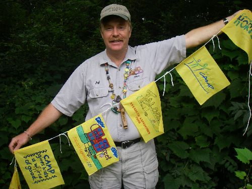 A few of the first expedition flags that were sent to him by schools and camps