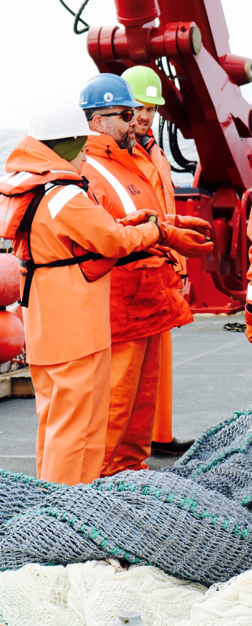 Dr. Mike Lowe confers with Ph.D. candidates Chrissy Hernandez and Justin Suca about the mid-water trawl net&#39;s upcoming deployment off of the R/V Sikuliaq.  August/September 2017.  Photo by Lisa Seff.