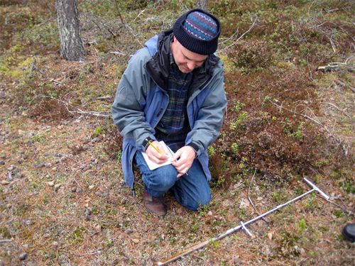 Wing records the soil horizons in his field notebook