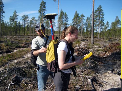 Greg Korosec outfits Sarah Billiar with the GPS Rover pole