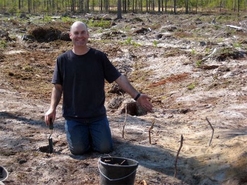 Wing is very proud of his &quot;rock garden.&quot;  Each stick marks the location of a stone.