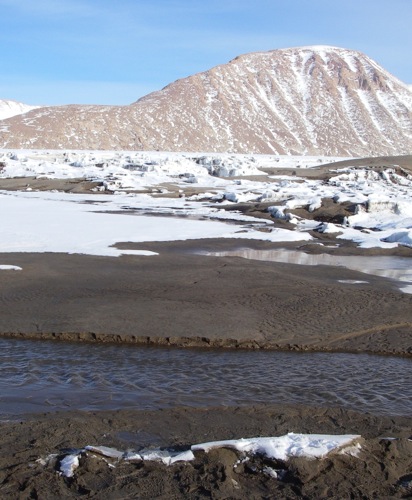 Blue water, black rock, white snow, red mountain