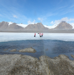 This small boat attached to ropes and a pulley system is used to ferry people and equipment across the moat to the lake ice. Photo by Joshua Heward. 