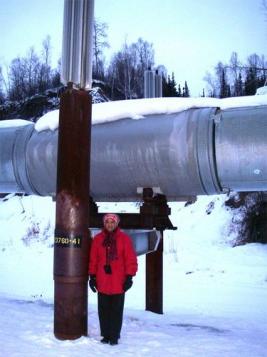 PolarTREC teacher Jackie Hams beneath  the Trans Alaska Pipeline