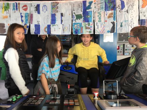 Anvil City Science Academy middle school students on the bridge and in the captains chair onboard the R/V Sikuliaq. Photo by Lisa Seff.  September 18, 2017.