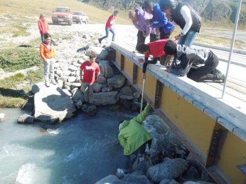 Taking measurements to calculate stream discharge.