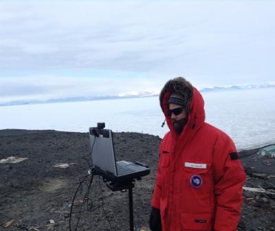 Josh Heward tests equipment in preparation for his upcoming PolarConnect event. Observation Hill, McMurdo Station, Antarctica. Credit to Read:  Photo by Jim Madsen, Courtesy of Joshua Heward (PolarTREC 2016), Courtesy of ARCUS