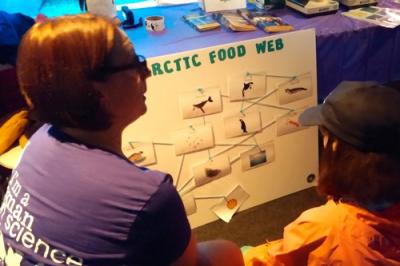 Cara at Mystic Aquarium Women in Science Day talking to a student.