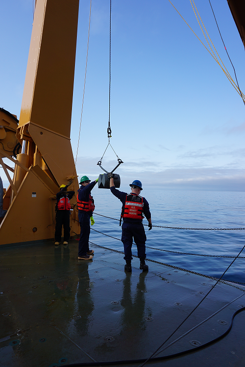 The Coast Guard guiding the van Veen grab off the back of the USCGC Healy.