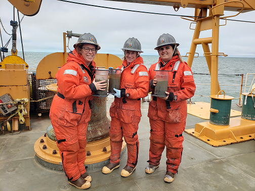 Christina Goethl, Nicole Villeneuve, and Piper Bartlett-Browne holding HAPs cores. (Photo courtesy of Dr. Lee Cooper)