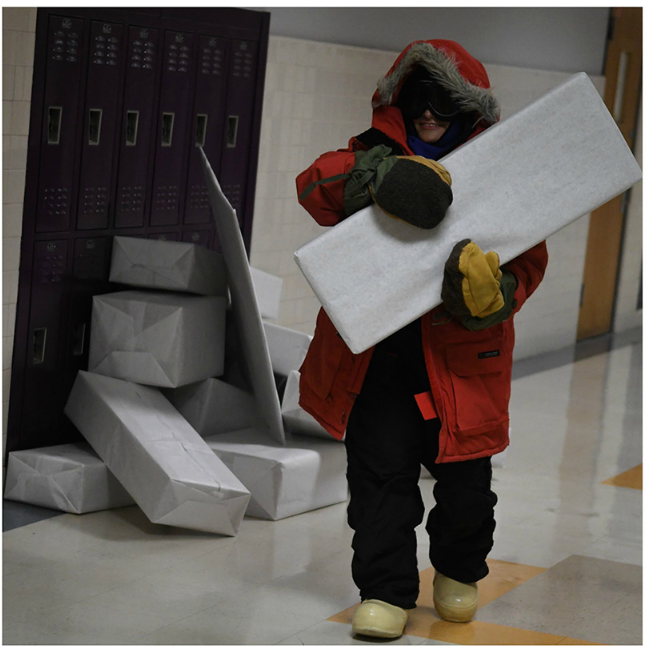 Student participating in a class project entitled,Polar-ympics, transporting“ice blocks”for construction of an igloo. (Photo by Daphne Lynd.)