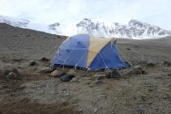 Boulders around the tent keep it anchored down in strong winds. Lake Bonney, Antarctica.