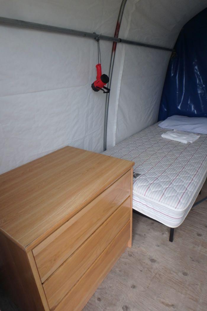 The WeatherPort even has a dresser and a mattress!