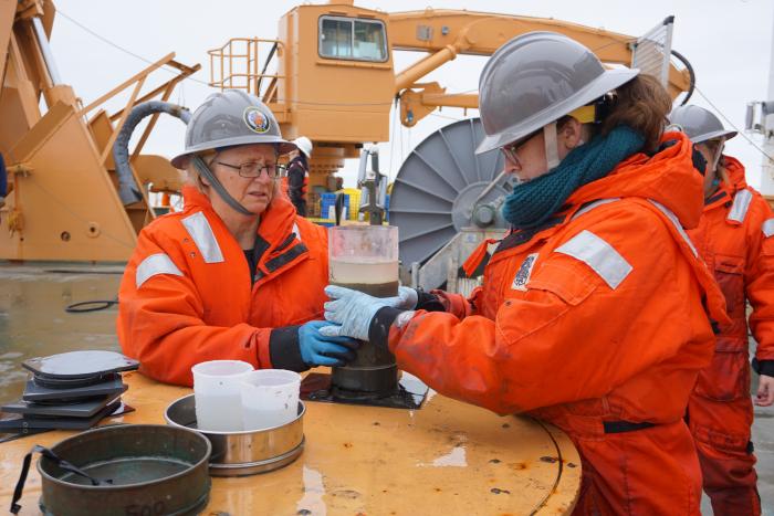 Jackie Grebmeier and Kelly Kapsar prepare a benthic core for experimentation.