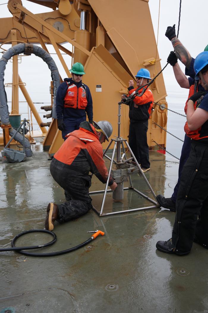 Dr. Lee Cooper puts in the empty core cylinder and liner for deployment.