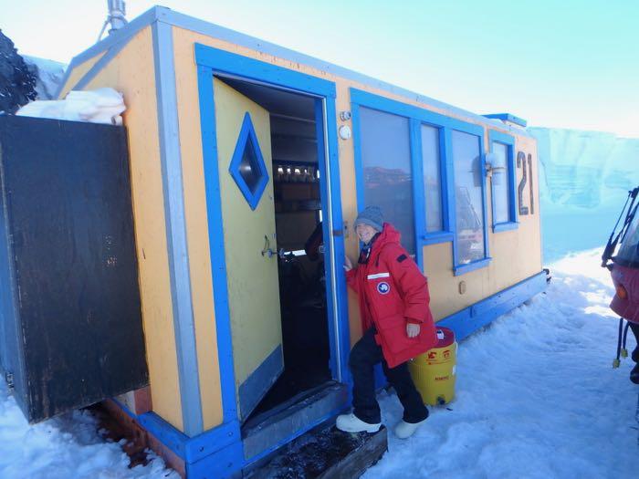 Amy Osborne enters the yellow and blue dive hut at Evans Wall near Cape Evans.