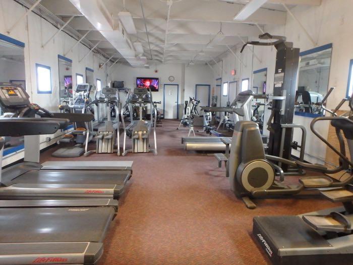 treadmills, bikes, rowing machines in an exercise room