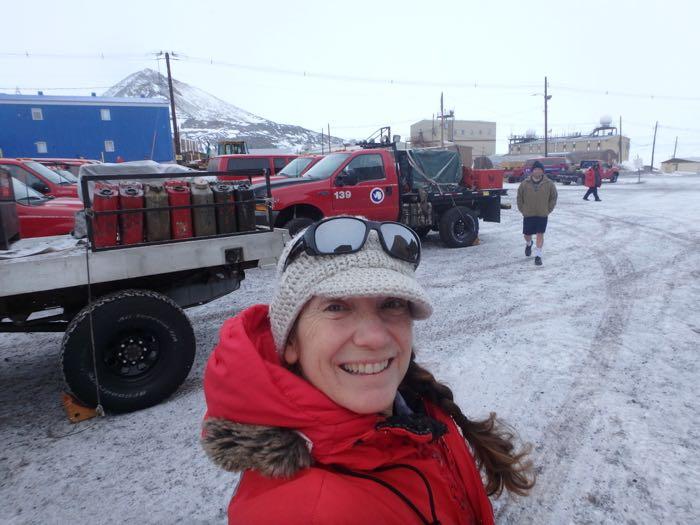 Amy Osborne in standing in front of vans with snow on them.