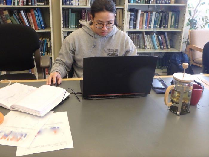 A scientist looks at data on a computer.