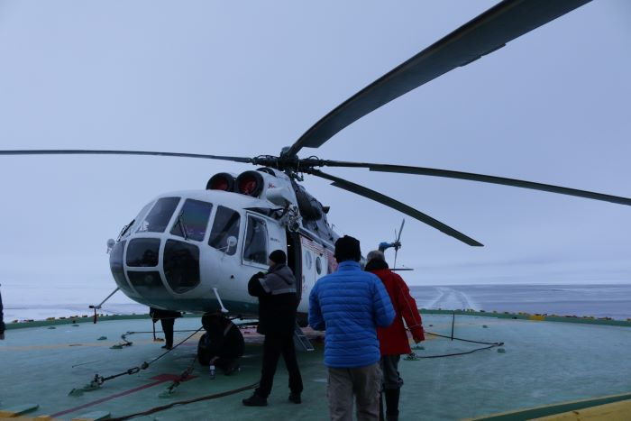 People boarding helicopter.