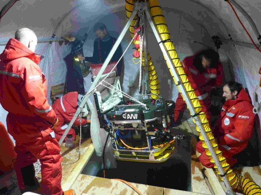 Equipment and researchers in a tent