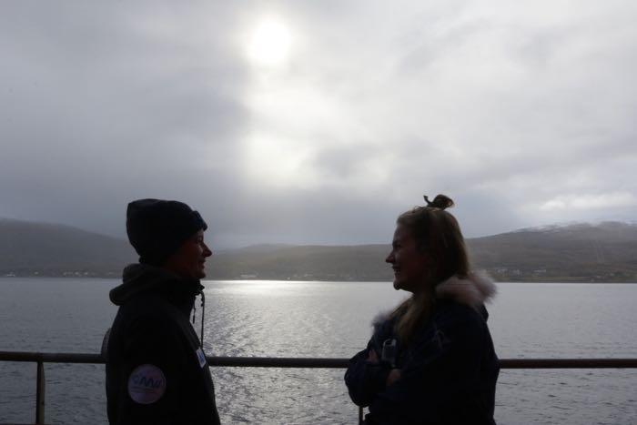 Two people speaking on deck