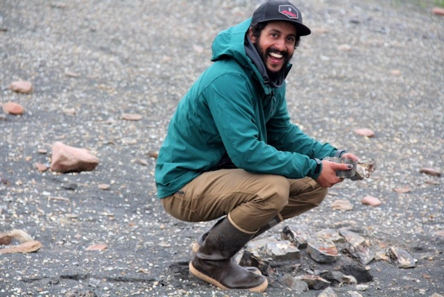 Manny holds open some rocks. 