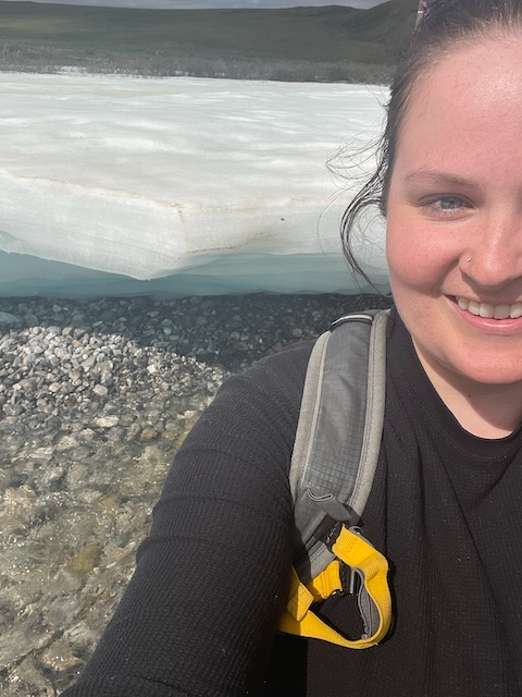 Liza stands in front of a block of laminated ice. 