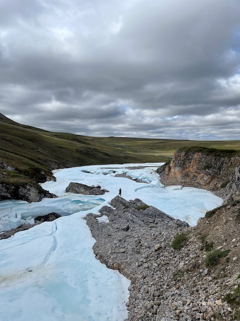 Jeremy stands very tiny surrounded by massive amounts of ice. 