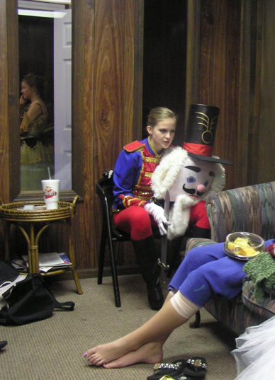 Liza in a red and blue Nutcracker outfit.