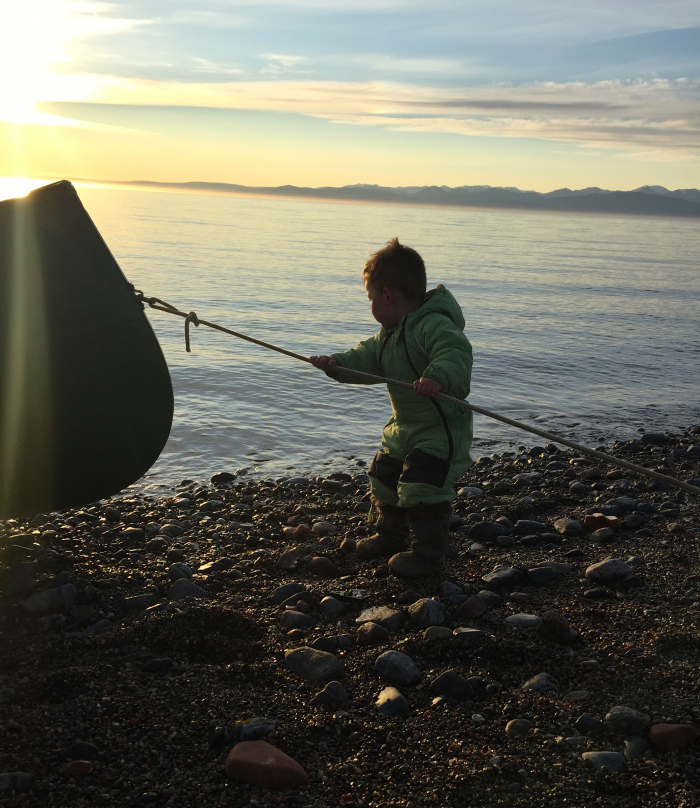 Young Inuit boy helping out with one of the boats