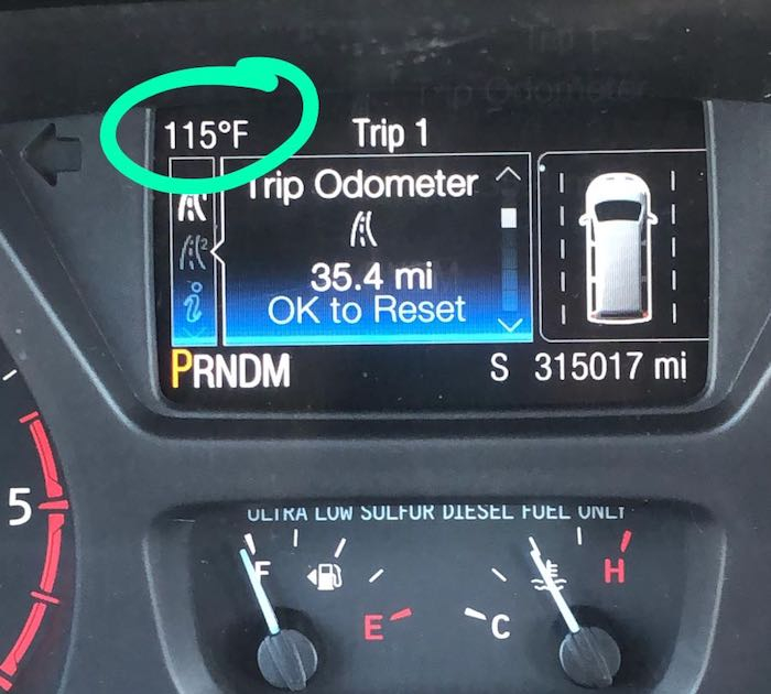 Car dashboard display showing extreme temperature