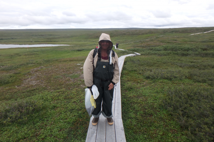 Svea Anderson carries a bag containing a cut quadrat sample