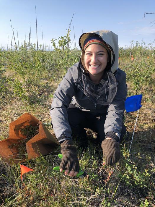 Educator Amanda Ruland collects vegetation for competition experiment photographed by Jennie DeMarco