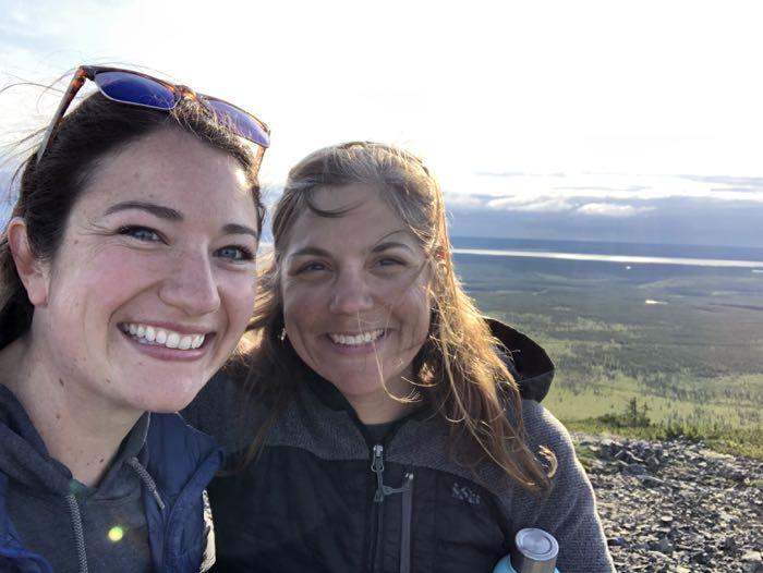 Educator Amanda Ruland and researcher Jennie DeMarco overlooking a boreal forest photographed by Amanda Ruland