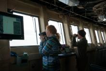 Charlie and Linnaea Wright of US Fish and Wildlife counting and identifying birds on the bridge of the Healy.