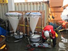 Jonaotaro Onodera (JAMSTEC) collecting samples from the sediment trap bottles.