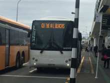 Sign on bus that reads "Go the All Blacks"